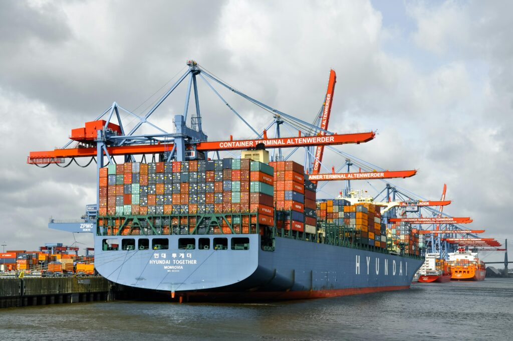 Large container ship docked at Hamburg port, showcasing global trade and logistics.